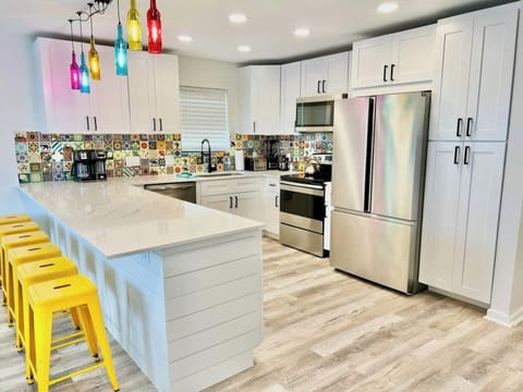 Fully equipped modern kitchen with oversized island and stainless appliances
