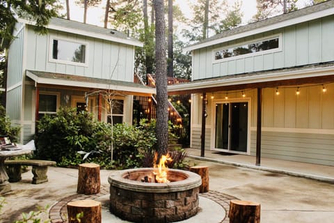 Courtyard & firepit area. Main house with covered patio area (right).
