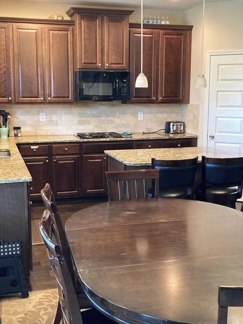 Kitchen with seating for 6 at table, 2 at bar, and all dining necessities