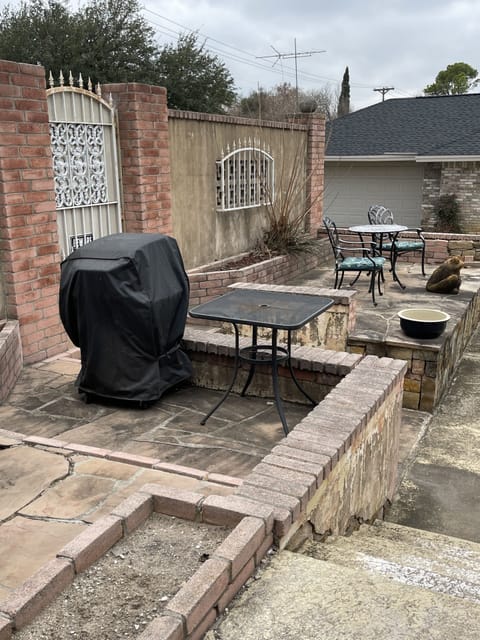 Patio area reserved for guests with table, chairs and gas grill