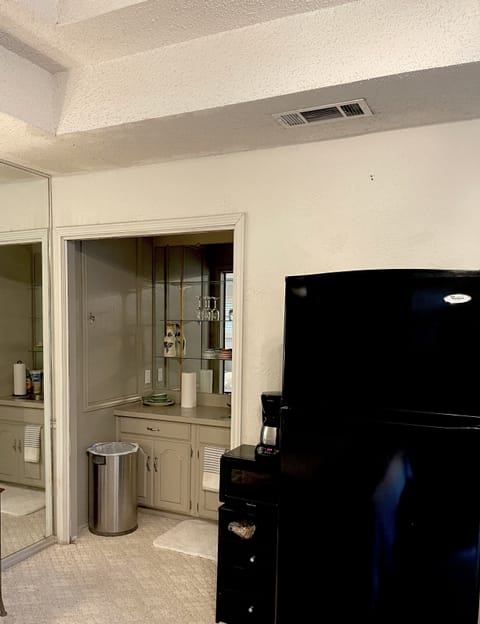 Kitchenette with full refrigerator, microwave, coffee maker and wet bar