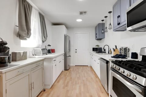 All the kitchen supplies are nicely organized in our newly refurburished cabinets. Plates, bowls, utensils, glassware, wine, appliance, kitchen cleaning supplies, knives and cutting board. 