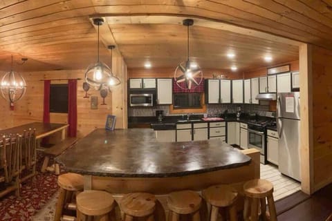 Mountain Leisure Retreat offers an open floor plan that allows your guests to mingle while cooking, eating, playing a game of pool or cards, or enjoying a movie or game while lounging on the couches. 