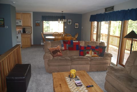 Open living room/dining area.   Lots of windows.