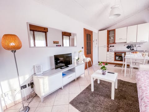 Bright living room with fully equipped kitchenette, enriched by a comfortable sofa bed and a modern 32" flat screen TV for your total relaxation.