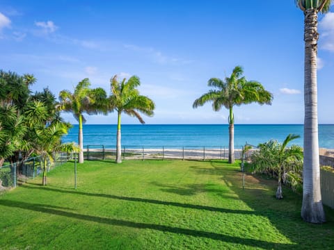 Large yard leading directly out to the sandy beach
