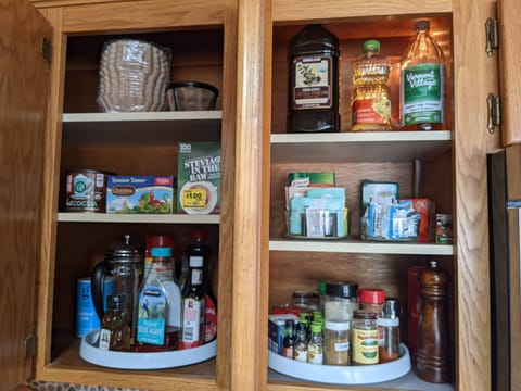 There are utensils, spices and oils for cooking. Specific items will vary.