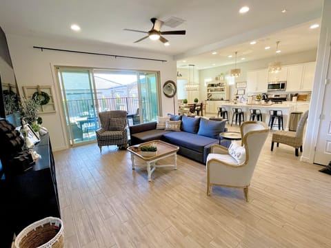 Living Room with large open sliding doors to outside patio & backyard