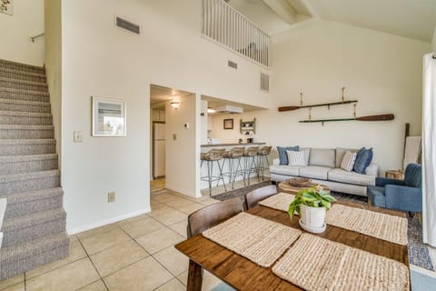 Sand Dollar 206 East main level — open-concept living, dining, and kitchen layout with tile floors and bright coastal design. Vacation rental Pensacola Beach, Florida.
