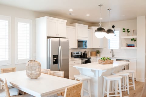 Fully equipped kitchen featuring island seating and stainless appliances.