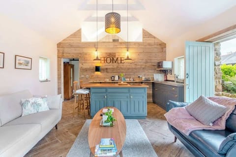 Open plan seating and kitchen area. Stable doors and patio door provide plenty of light and access to the surrounding gardens.