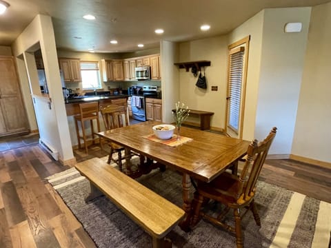 View of fully stocked kitchen from dining table.