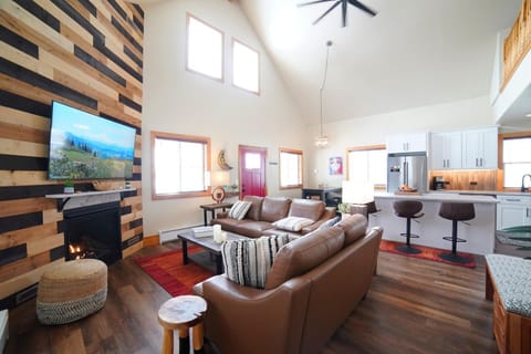 Whether you are relaxing in the living room, eating at the dining room table, or hanging in the kitchen, you are always a part of the fun in this home. 