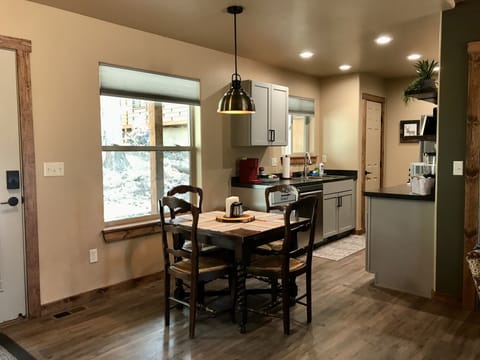 Dining area with antique drop leaf table. Leaves slip out manually.