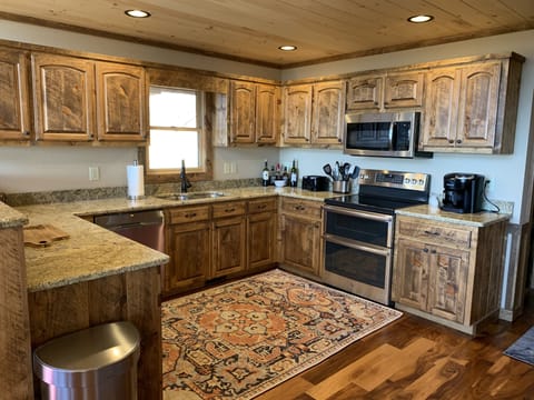 Spacious kitchen is full equipped and feature stainless appliances and granite.