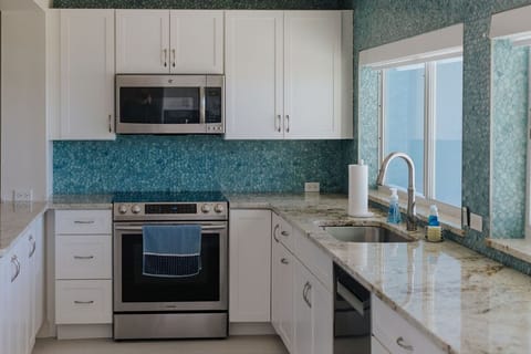 Kitchen with microwave, stove/oven combo, dishwasher