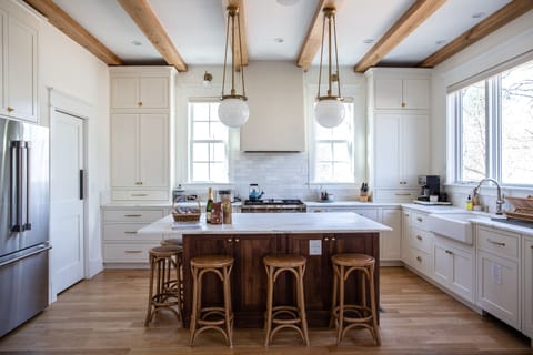 Designer kitchen with marble countertops, farmhouse sink, and Bosch appliances.