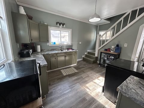 Full kitchen and stair access to second floor