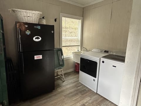 Laundry room with extra fridge and fire pit access through back door