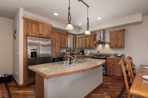 - Fully equipped kitchen with granite island, pendant lighting, and stainless appliances - Rich wood cabinetry and curved countertop create a warm, lodge style feel - Ideal for home cooked meals, morning coffee, or gathering around together