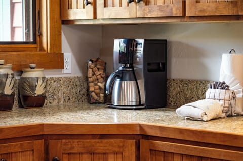 - Coffee station ready to fuel your mornings with a sleek stainless brewer - Granite countertops and wood cabinetry offer charm and convenience - Wake up and start your day with a fresh brew just steps from the dining area