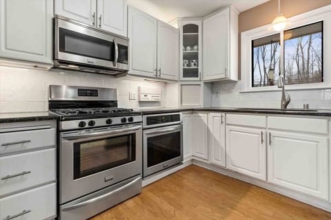 Prepare your favorite dishes in a kitchen that combines style and functionality, complete with modern appliances.