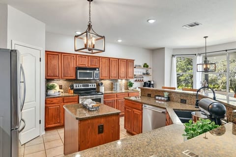 Bright and open, the kitchen overlooks the backyard—perfect for gathering, meal prep, and connecting with family and friends.