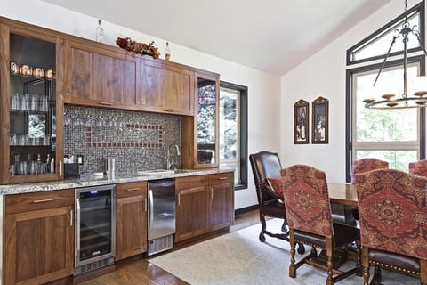 Built in bar with wine fridge and glassware for all of your cocktail needs.