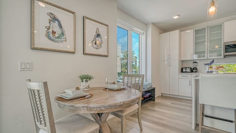 A 2-chair bistro-style dining table sits just off the living space—ideal for quick bites or quiet mornings.