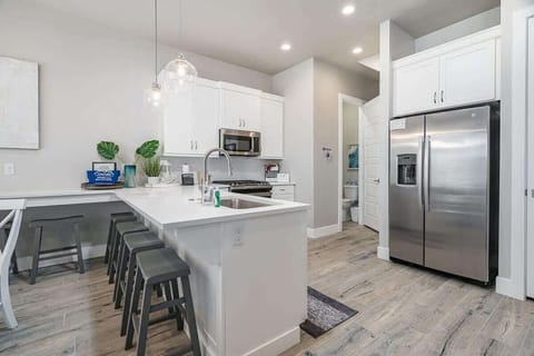 Gorgeous open concept airy kitchen with extended bar seating