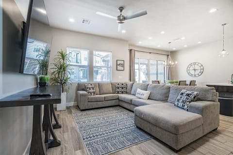 Open concept family room with comfortable sectional sofa and TV