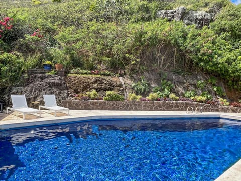 Take a refreshing dip in your private solar-heated pool nestled against the lush mountainside.