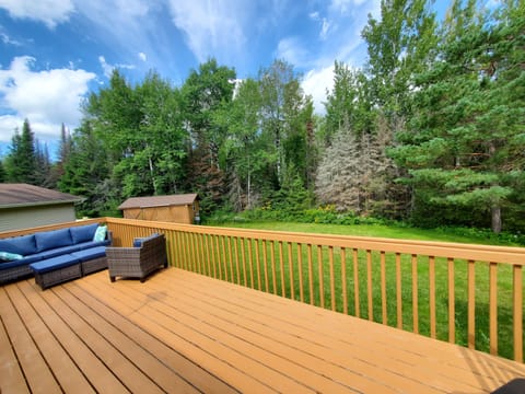 Big back deck with comfy seating and picnic table.