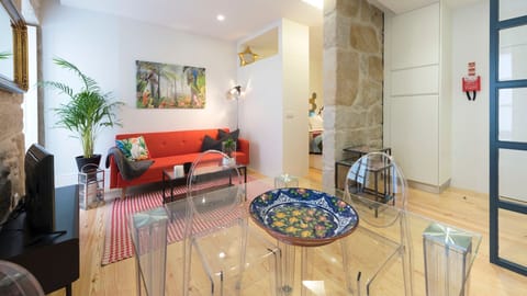 A bright and characterful living space where original stone details meet colourful modern decor.
#livingroom #design #character #Portugal #Porto