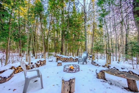 Enjoy the outside firepit with wood and plenty of seating.