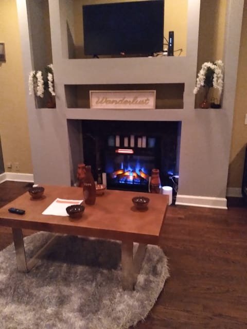 living room with smart tv  in celing dimmer lights and fireplace