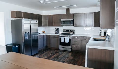 Large fully stocked kitchen with spices and all of the cooking supplies.