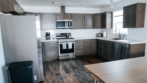 Large fully stocked kitchen with spices and all of the cooking supplies.