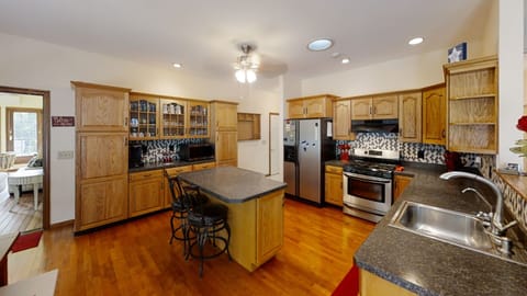 Kitchen view from living room area, sunroom door to the left
