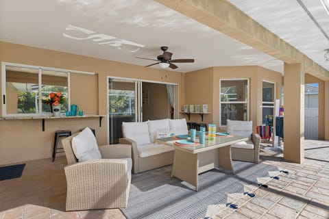 A lovely seating area that can also double as a dining area that overlooks the pool