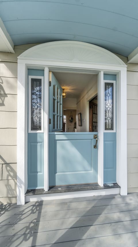 Classic Dutch door pulls you onto 
the front porch with its "haint blue" ceiling