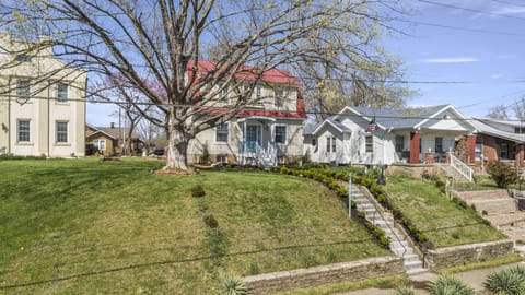 A cement staircase leads you up, Up, UP fifteen steps to the front yard.