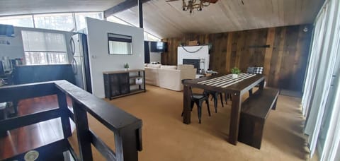 Open concept living space with large farm table for gathering 