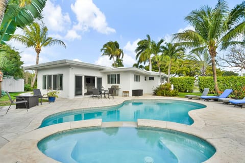 Quality family home, enticing yard with pool, spa tub, outdoor dining and tropical planting.