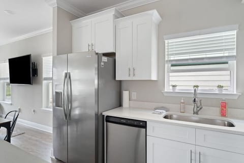 Fully equipped kitchen with all cooking and baking supplies, gas stove, and dishwasher. Grill tools available for outdoor grill. Dining area seats 6 with 4 at the table and 2 at kitchen island. Regular drip coffee maker.