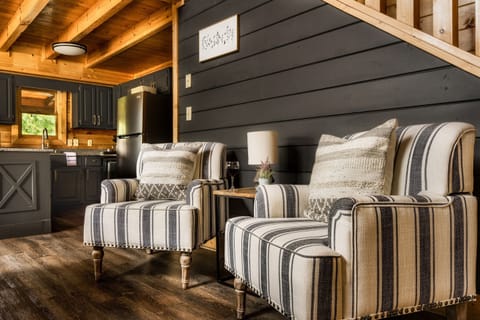 Cozy reading nook at the base of the stairs- which lead up to king BR suite and another bedroom with2 queens.