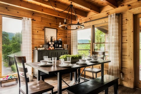 Dining area at the Roost, with Smoky Mountains beyond. Additional seating at kitchen island.