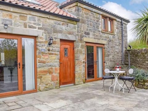 Enclosed patio with outside dining table and chairs