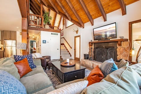 Come relax on this couch in front of the wood-burning fireplace!
