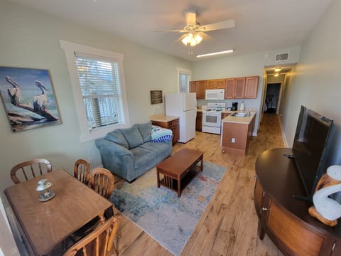 Large kitchen with dishwasher open to living and dining